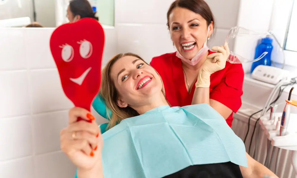 Patient holding a dental mirror during a dental visit